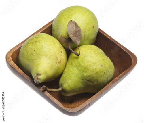 Three fresh pears in a wooden bowl.