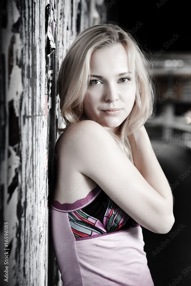 Naklejka premium Young Pretty Woman Against Grunge Wall
