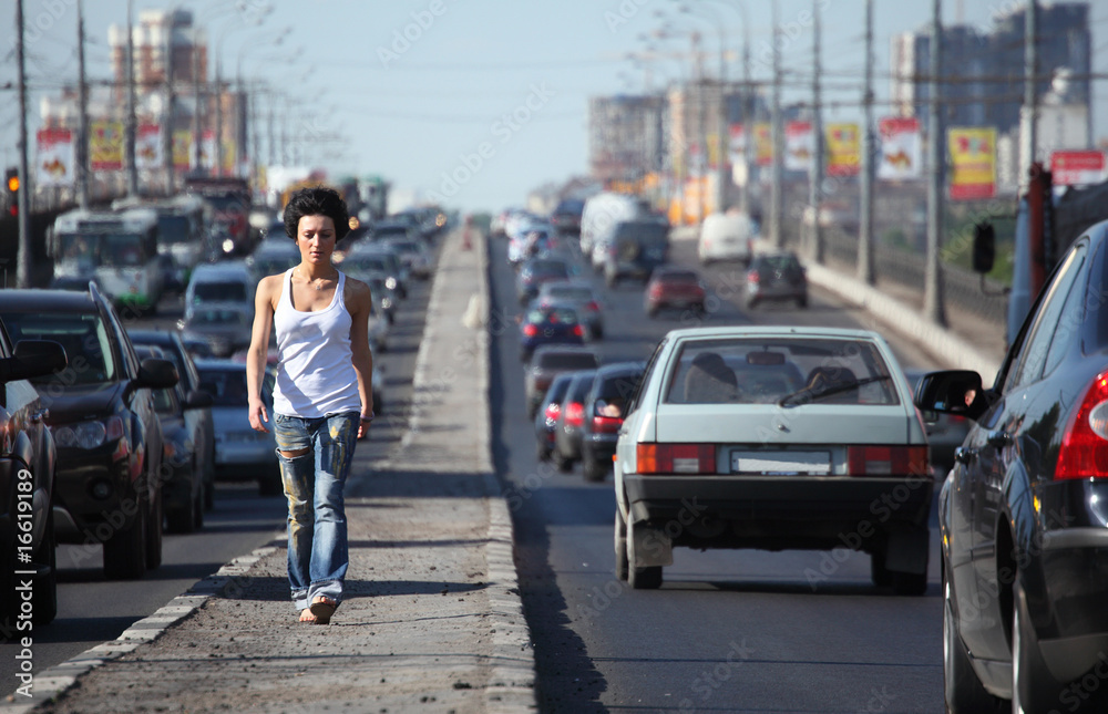 girl goes on highway middle in city