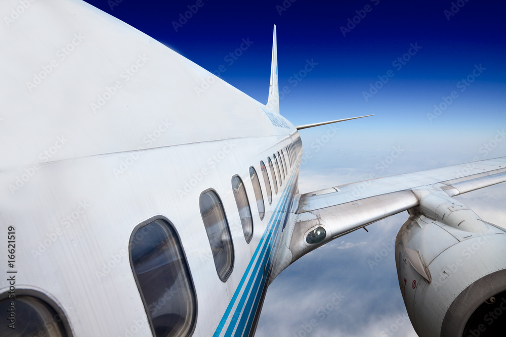 Fototapeta premium the airplane with the blue sky background.
