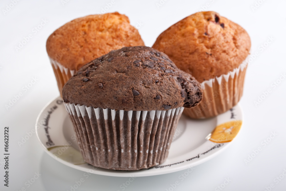 three muffins on a plate three muffins on a plate