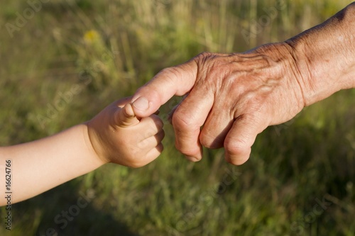 hand of grandmother and grandchild © Renáta Sedmáková