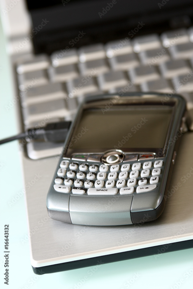 mobile office: smartphone over a laptop mobile office: smartphone over a laptop