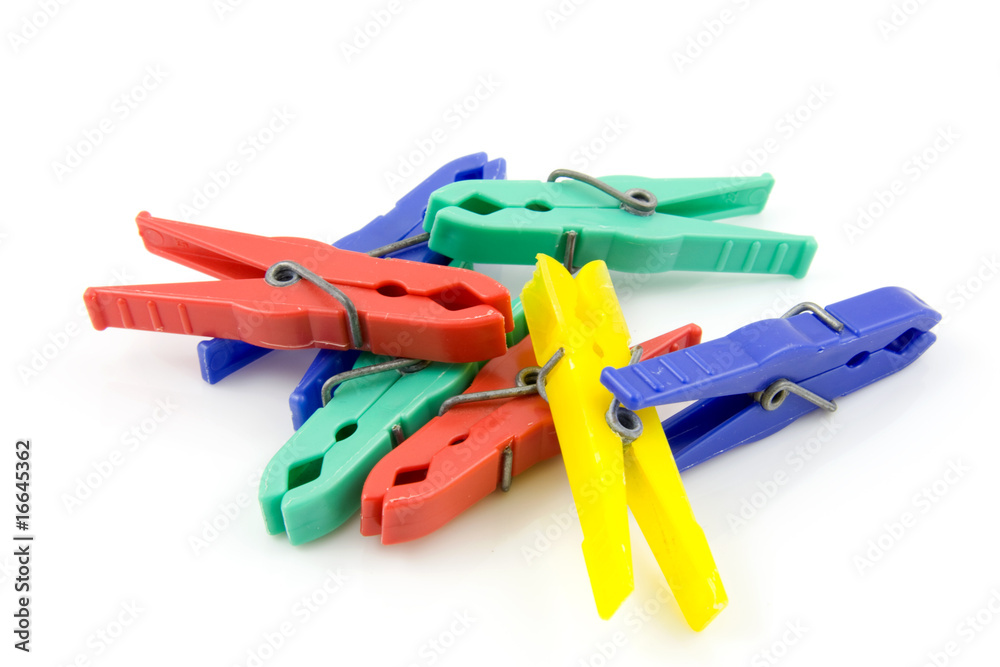 Colorful plastic clothespins over white backgound