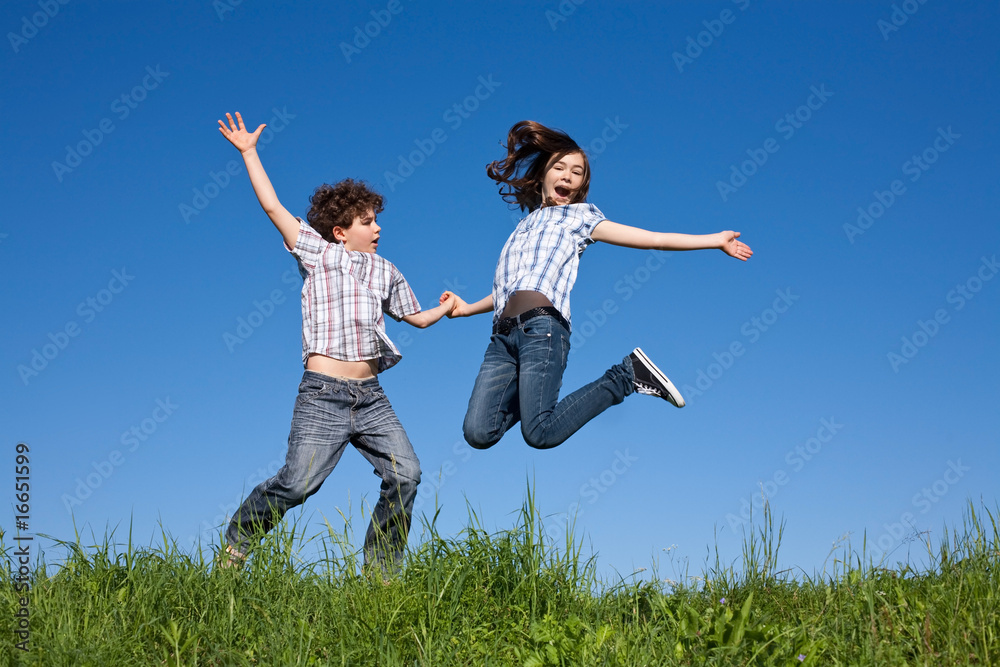Kids running, jumping on green meadow Kids running, jumping on green meadow