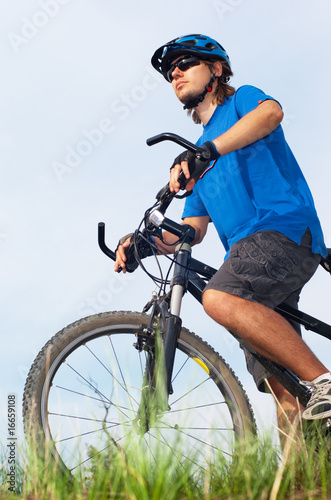 Fototapeta Naklejka Na Ścianę i Meble -  young bicyclist in helmet