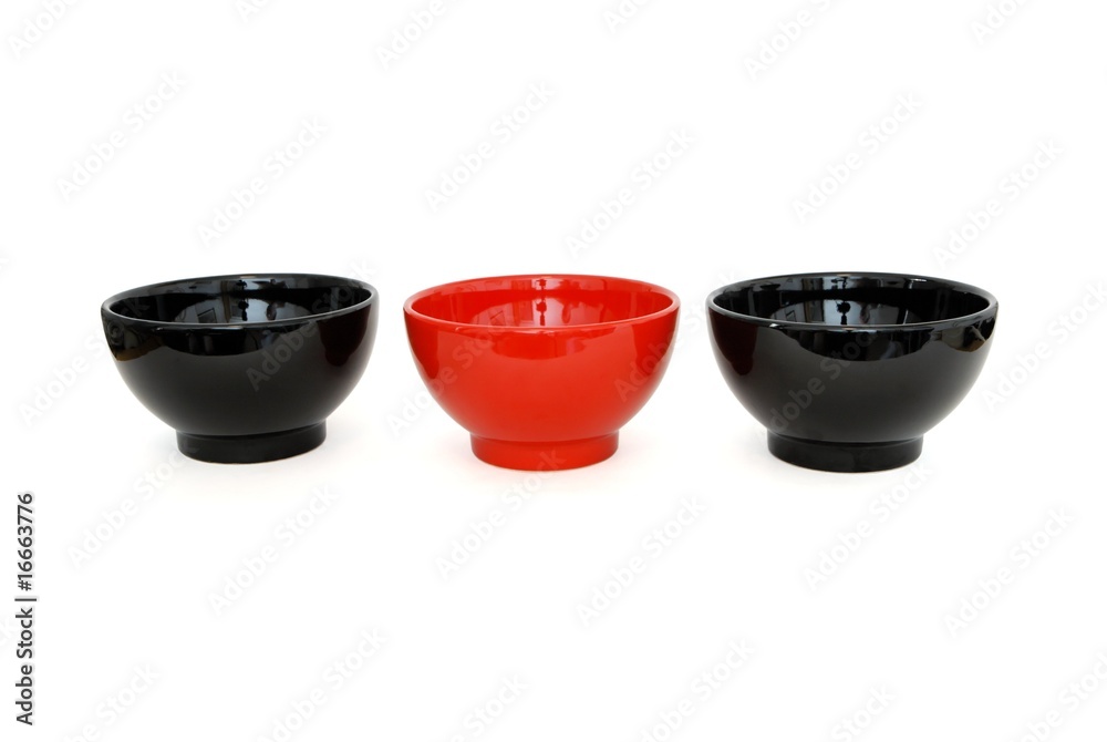 Row of two black and one red porcelain bowls isolated Row of two black and one red porcelain bowls isolated