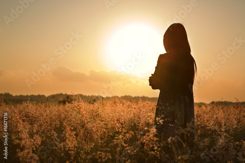 Woman silhouette waiting for summer sun
