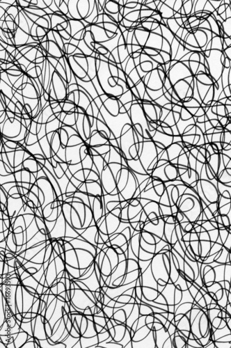 Black ink scribble abstract pattern on white paper.