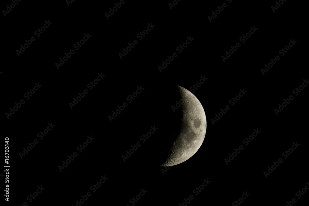 Waxing crescent moon closeup isolated against a black night sky Waxing crescent moon closeup isolated against a black night sky