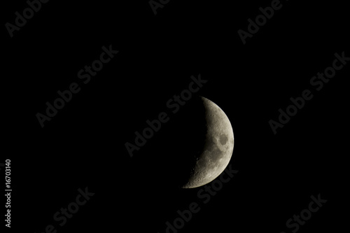 Waxing crescent moon closeup isolated against a black night sky
