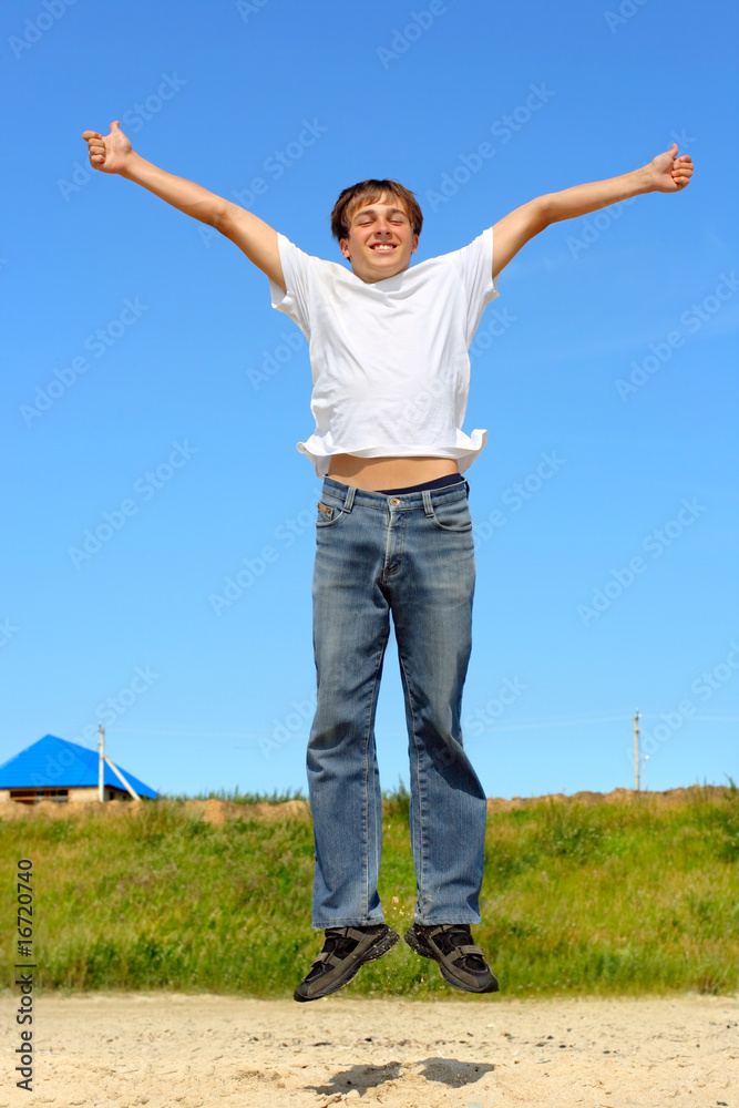 happy teenager jumping on the beach happy teenager jumping on the beach