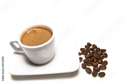 Cup of coffee and grains on a white background