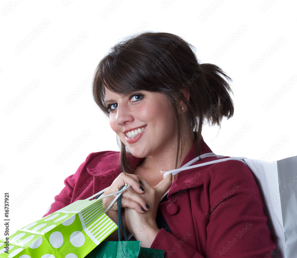 Young woman holding shopping bags; isolated on white Young woman holding shopping bags; isolated on white