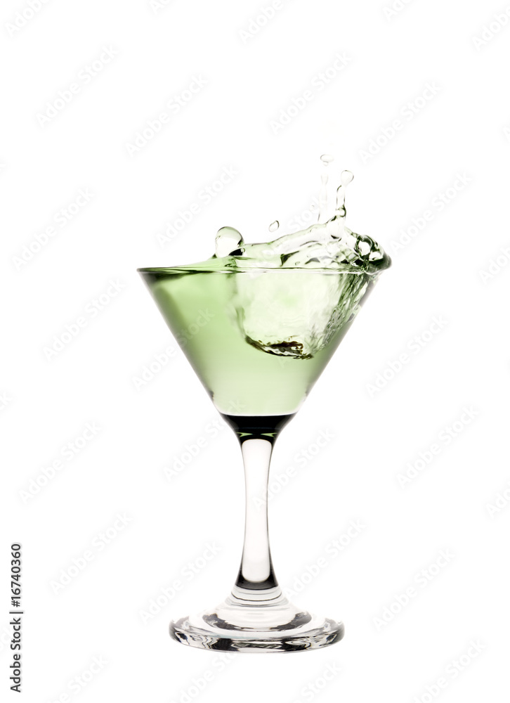 Green liquid splashing in a martini glass. Green liquid splashing in a martini glass.