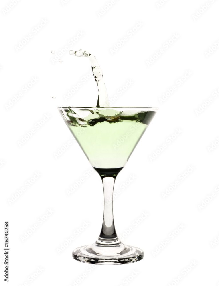 Green liquid splashing in a martini glass. Green liquid splashing in a martini glass.