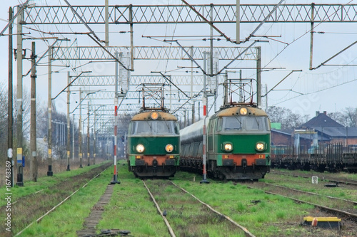 Freight trains with electric locomotives waiting at station