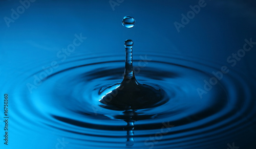 close up of a drop of water in blue colors