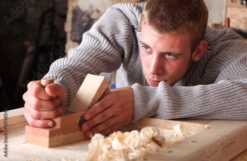 Young man working with plane