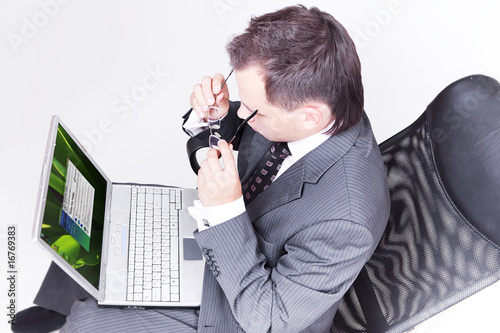 Businessman sitting and using laptop computer.