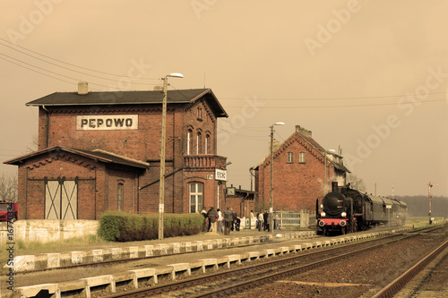 Old retro steam train stopped at the small station