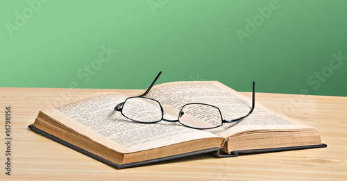 Eyeglasses on open book photo