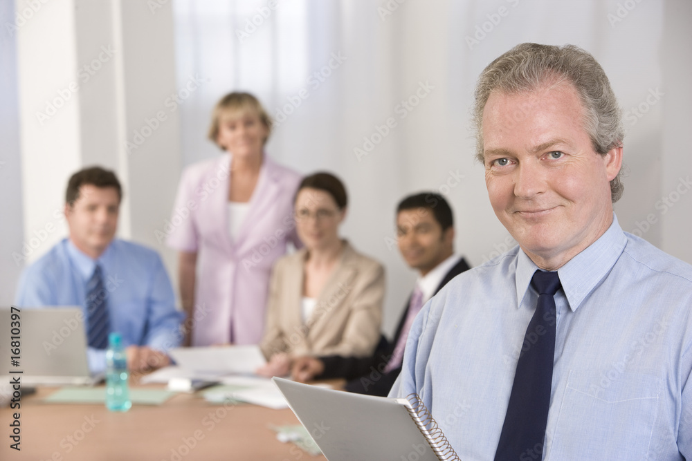 Portrait of businessman and his team. Portrait of businessman and his team.