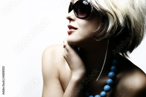 Fashion woman portrait wearing sunglasses on white background