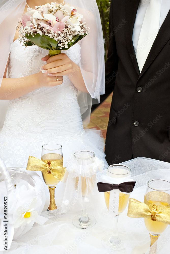 bride and groom near wedding decorated table with wine glasses bride and groom near wedding decorated table with wine glasses