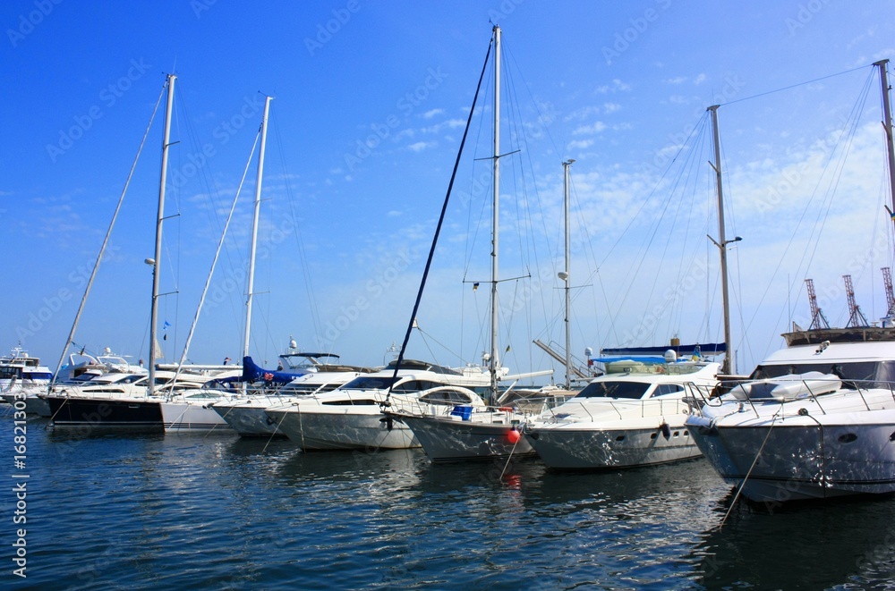 a row of yachts anchored in the harbor