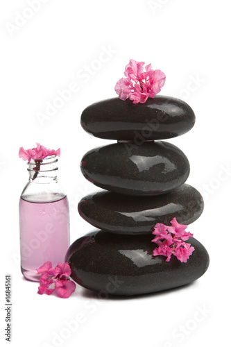 spa stones with flowers and cosmetic bottle isolated