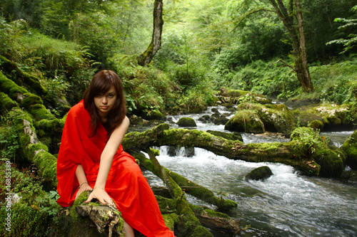 Girl in red at a brook