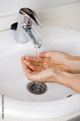 Washing hands in a sink as prevention against grip A photo