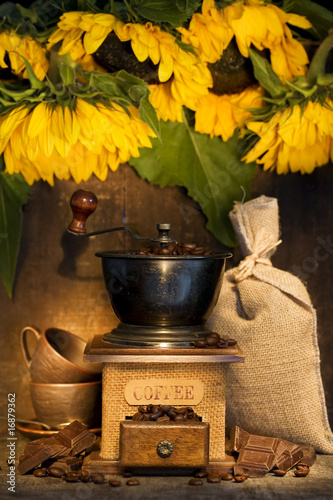 Stiill life with Antique coffee grinder and sunflowers photo