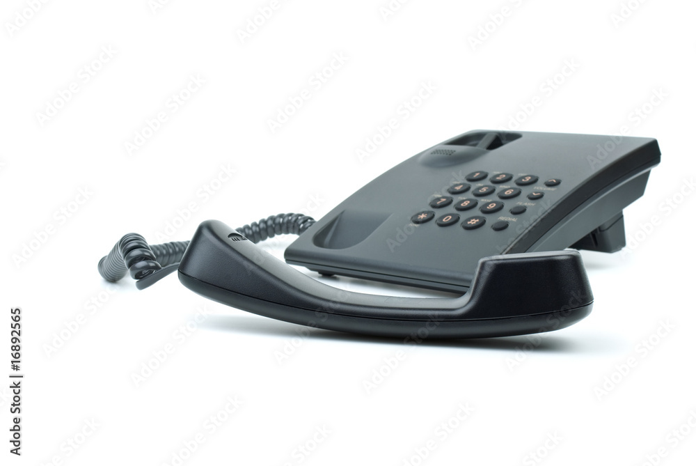 Black office phone with handset in foreground