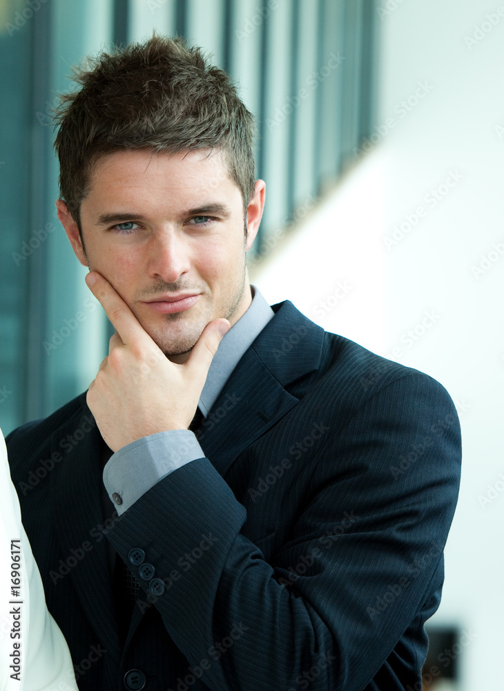 Attractive businessman smiling at the camera Attractive businessman smiling at the camera