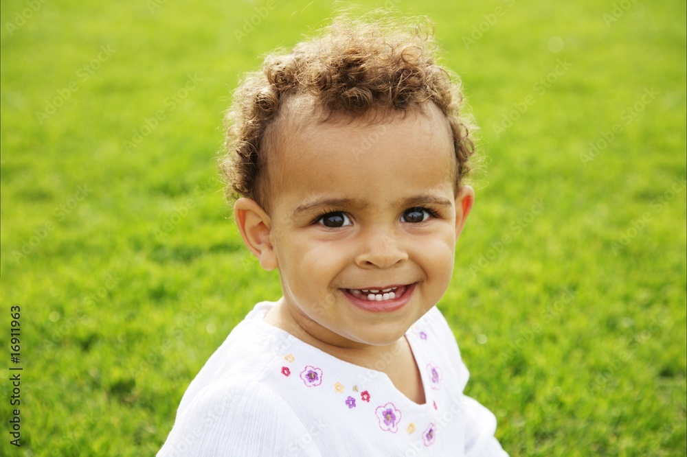 cute happy baby girl laughing on green grass cute happy baby girl laughing on green grass