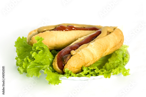 Tasty hot dog on lettuce leaves
