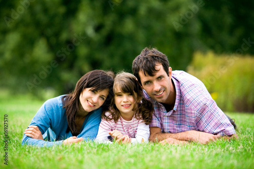 Family lying on grass