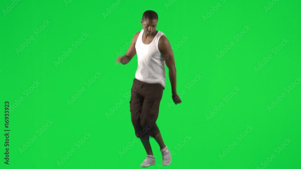 Young man dancing with a green background Young man dancing with a green background