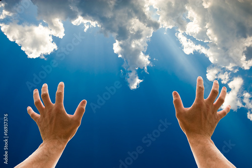 Two hands reaching for the sky