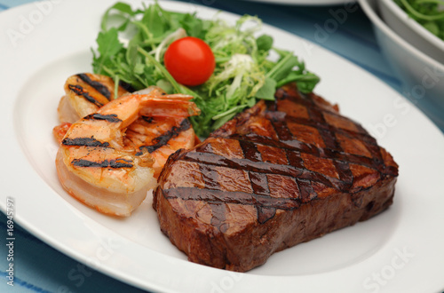 Juicy BBQ sirloin steak with grilled shrimps - Surf and Turf