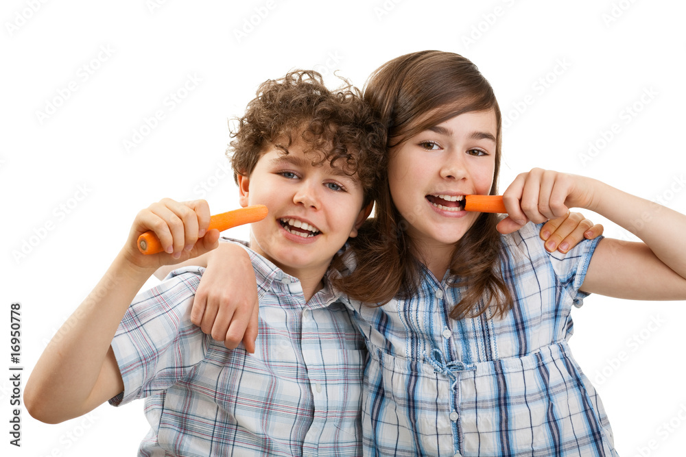 Kids eating fresh carrots isolated on white background Kids eating fresh carrots isolated on white background