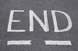 the end written in white on a road