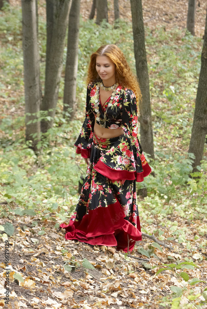 A beautiful ginger-haired girl in gipsy suit in forest A beautiful ginger-haired girl in gipsy suit in forest