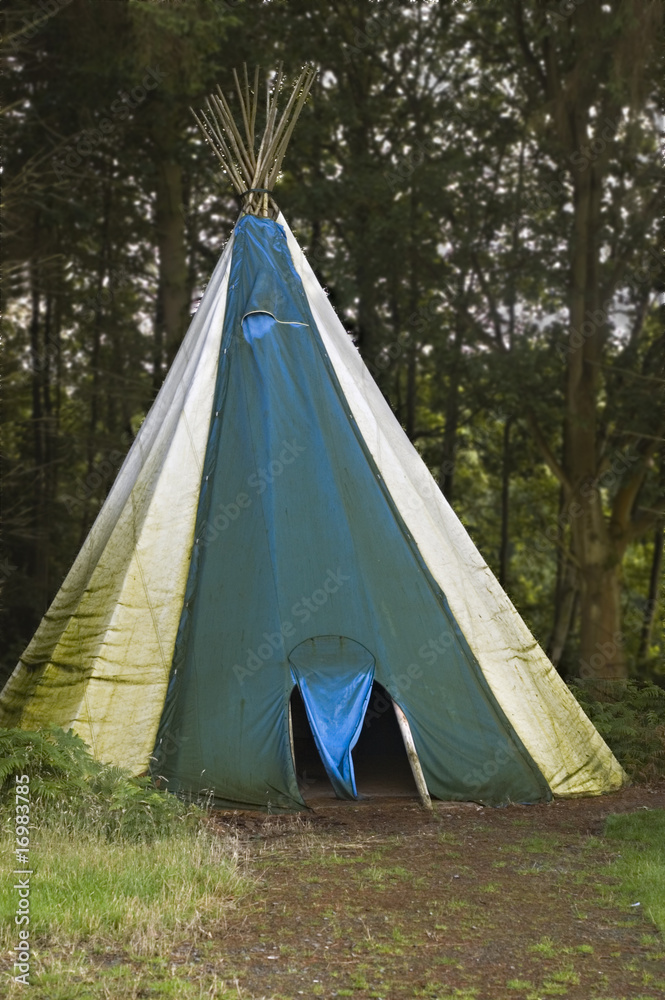 A teepee at a campsite in the woods
