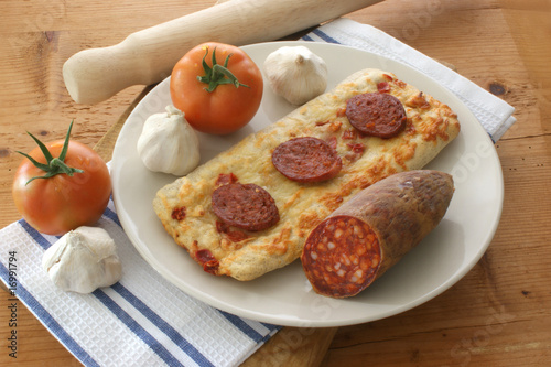 stone oven backed salami pizza, tomato and garlic