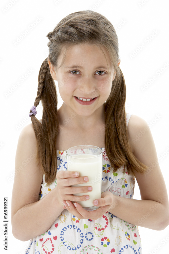 Studio Portrait of Smiling Girl Holding Glass of Milk Studio Portrait of Smiling Girl Holding Glass of Milk
