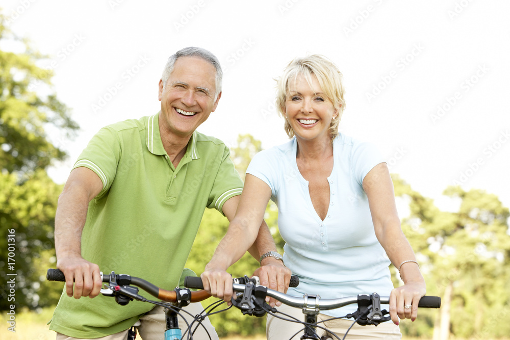 Fotografie Mature couple riding bikes