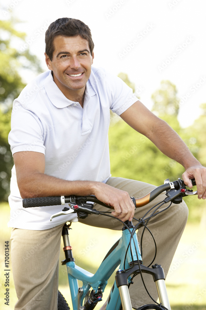 Young man riding bike in countryside Young man riding bike in countryside